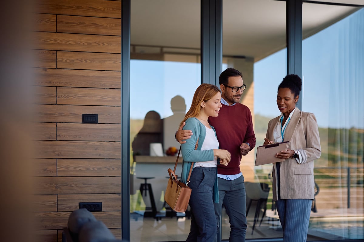 Real estate agent reviewing housing plans with a couple